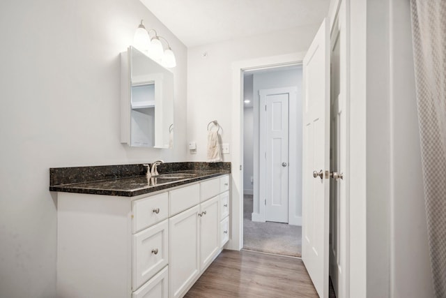 bathroom with vanity and hardwood / wood-style flooring