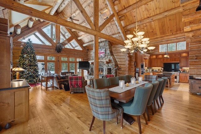 dining area featuring beam ceiling, high vaulted ceiling, light hardwood / wood-style flooring, and wooden ceiling