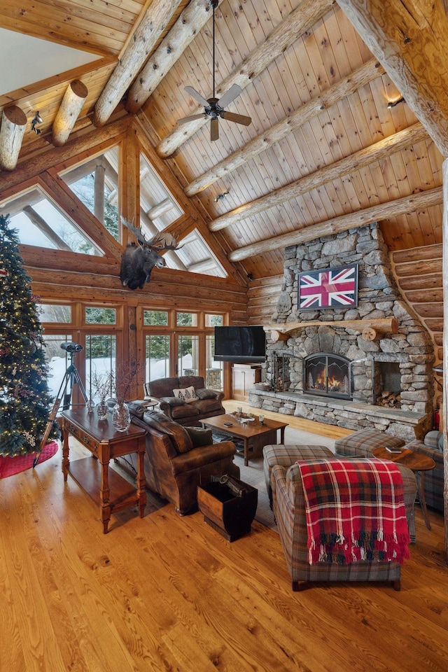 living room with hardwood / wood-style floors, wood ceiling, a fireplace, and beamed ceiling