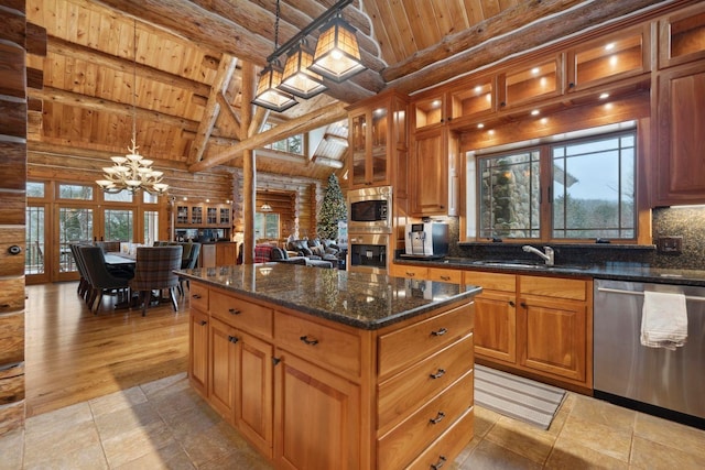 kitchen with sink, hanging light fixtures, a center island, stainless steel appliances, and wooden ceiling