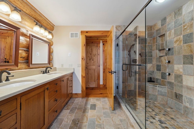 bathroom featuring an enclosed shower and vanity