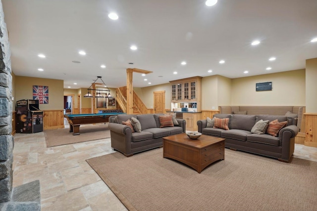 living room featuring pool table and wood walls