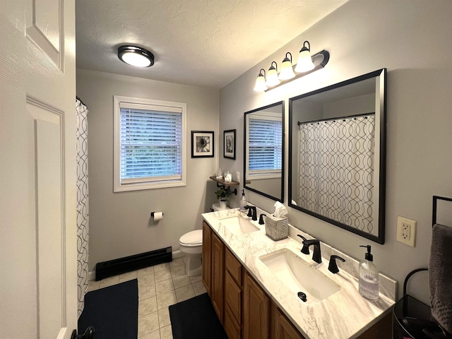 bathroom featuring tile patterned flooring, vanity, a textured ceiling, and toilet