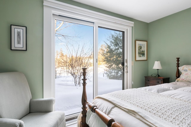 bedroom with multiple windows and access to outside