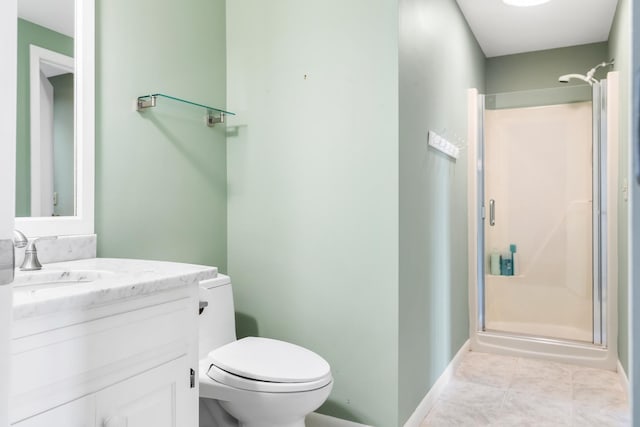 bathroom with vanity, tile patterned floors, toilet, and walk in shower