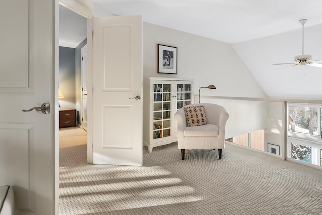 living area featuring french doors, ceiling fan, lofted ceiling, and carpet flooring