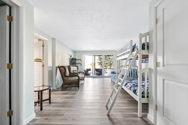 interior space with wood-type flooring and a textured ceiling