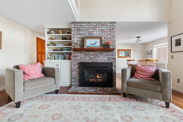 living room featuring hardwood / wood-style flooring and a fireplace