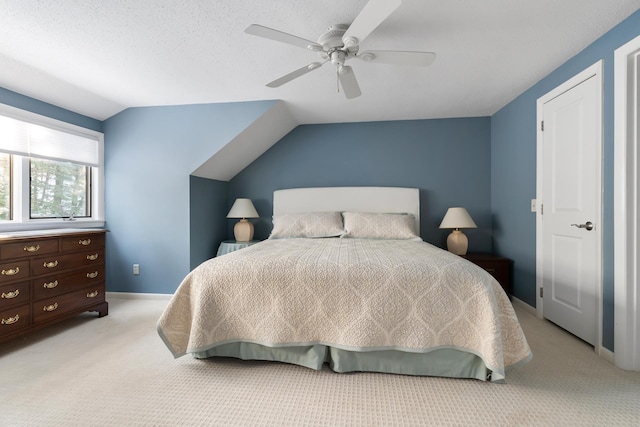 carpeted bedroom featuring lofted ceiling, a textured ceiling, and ceiling fan