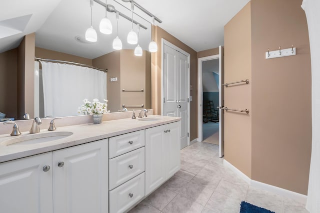 bathroom featuring tile patterned flooring and vanity