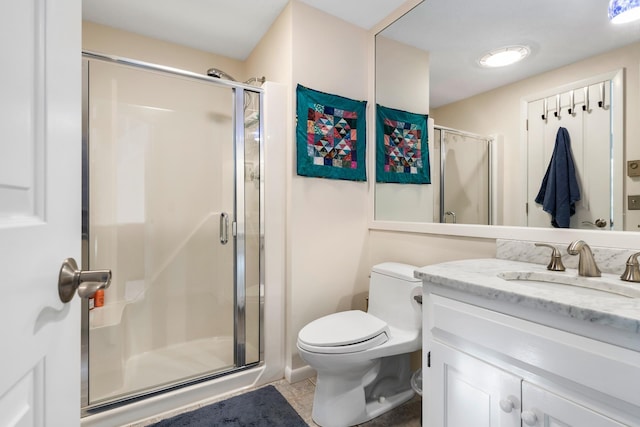 bathroom with tile patterned flooring, vanity, toilet, and a shower with shower door