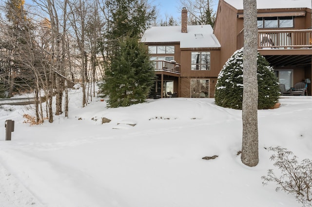 snow covered house with a balcony