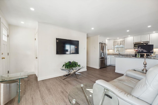 living room with sink and light hardwood / wood-style floors