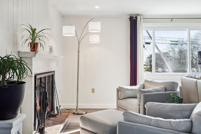 living room with hardwood / wood-style floors and crown molding