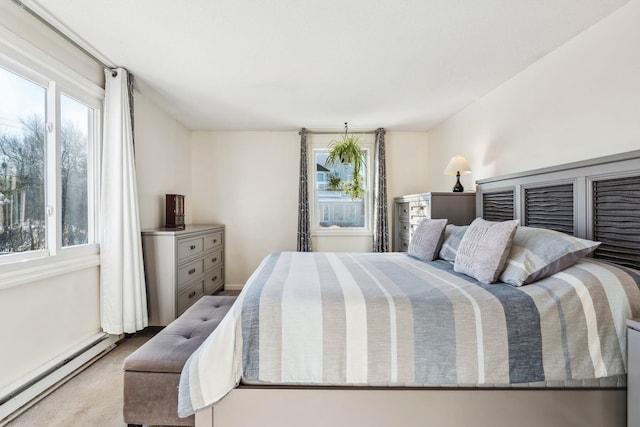 bedroom with a baseboard radiator and light colored carpet