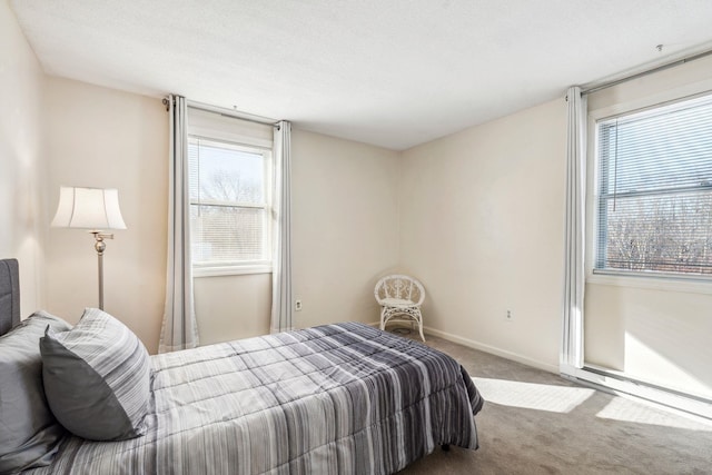 carpeted bedroom featuring multiple windows