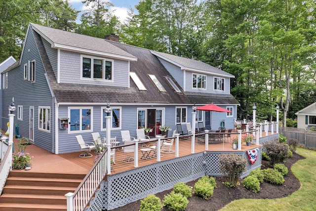 rear view of house featuring a deck