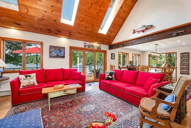 living room featuring a skylight, french doors, a chandelier, wooden ceiling, and light hardwood / wood-style flooring