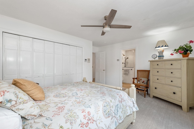 carpeted bedroom featuring ceiling fan, ensuite bathroom, and a closet