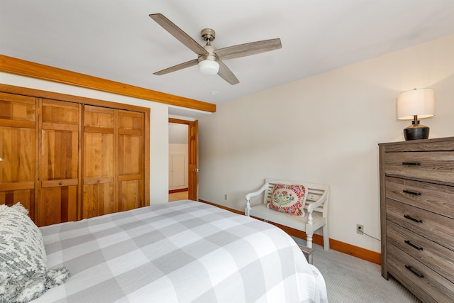 carpeted bedroom featuring a closet and ceiling fan