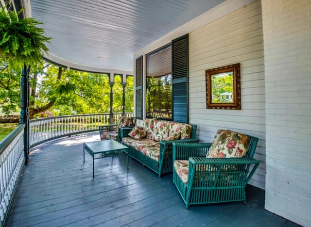 wooden deck with a porch and outdoor lounge area