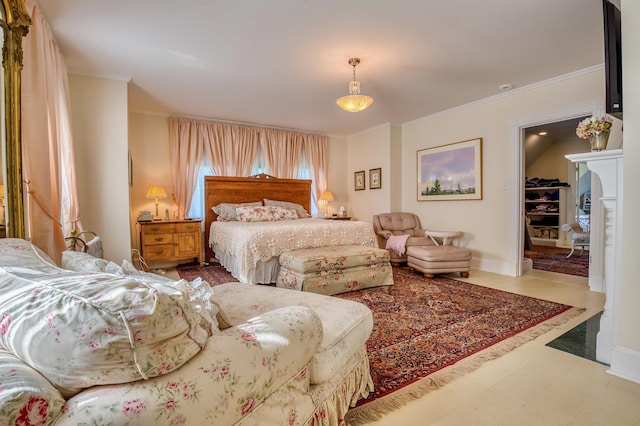 bedroom featuring crown molding, tile patterned floors, and a spacious closet