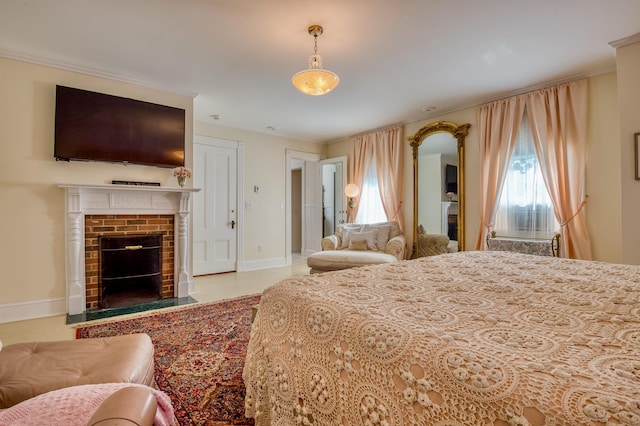 bedroom with multiple windows, a brick fireplace, and ornamental molding