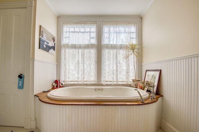 bathroom with a bathtub and ornamental molding