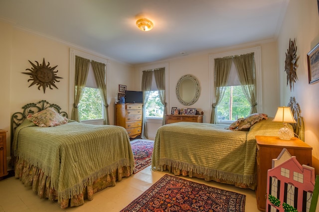 bedroom featuring multiple windows and crown molding