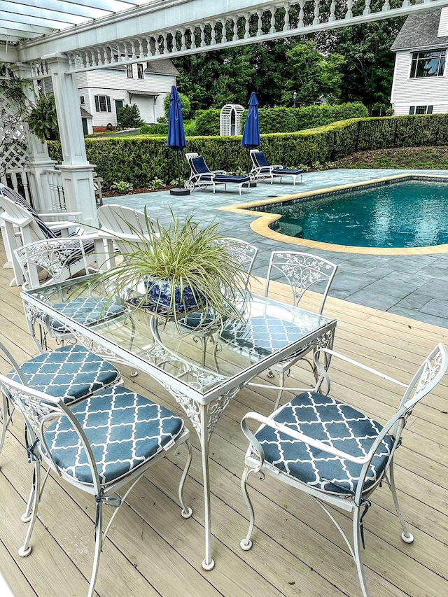 view of swimming pool featuring a pergola and a deck