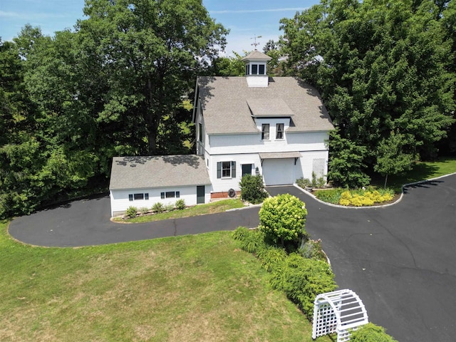 view of front of home with a garage and a front lawn