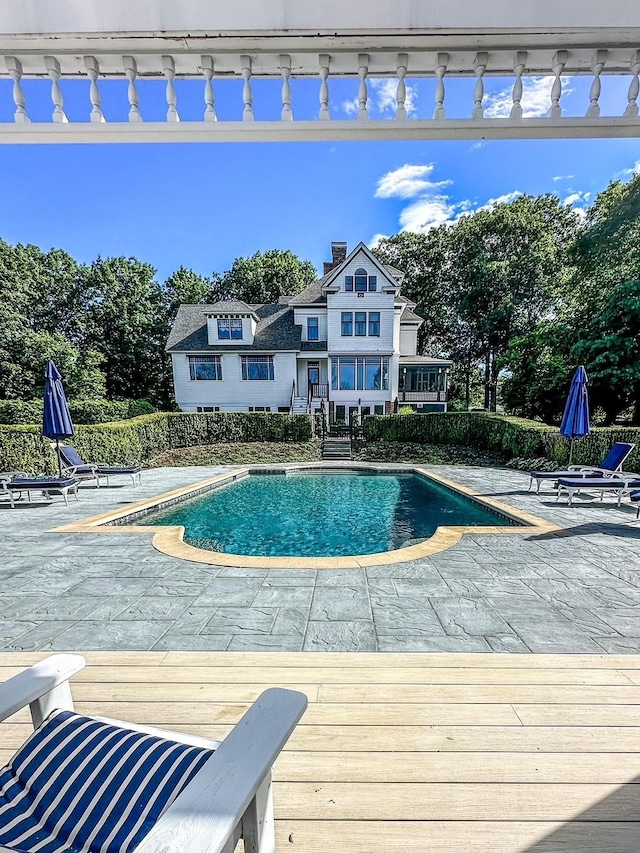 view of swimming pool featuring a patio area