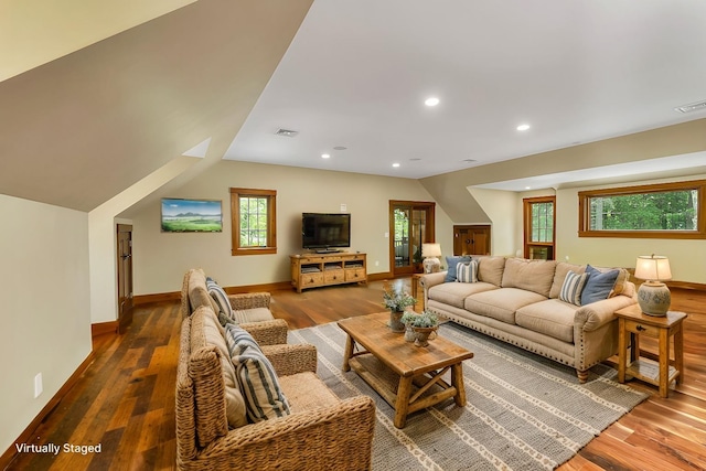 living room with lofted ceiling, dark hardwood / wood-style floors, and a healthy amount of sunlight