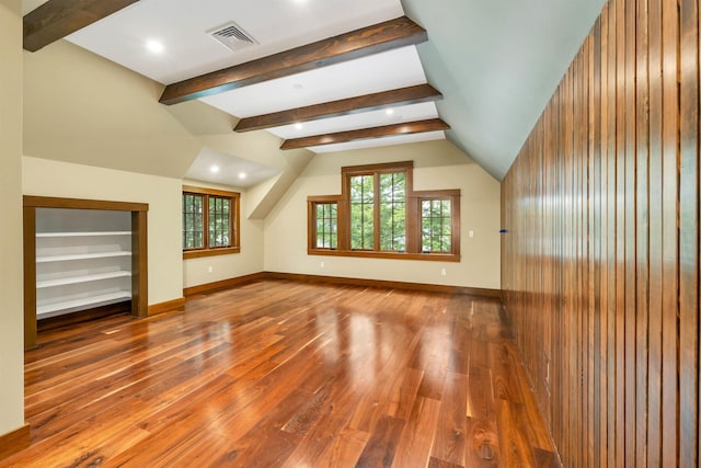 bonus room featuring wood-type flooring and vaulted ceiling with beams