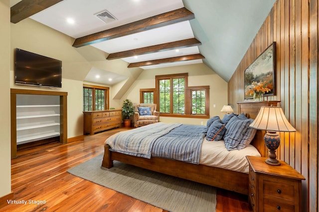 bedroom featuring beam ceiling and wood-type flooring