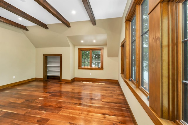 interior space with dark hardwood / wood-style floors and vaulted ceiling with beams