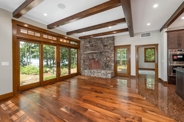 unfurnished living room featuring french doors, beam ceiling, and hardwood / wood-style floors