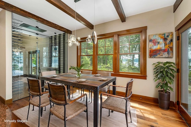 dining space featuring hardwood / wood-style flooring, an inviting chandelier, and beamed ceiling