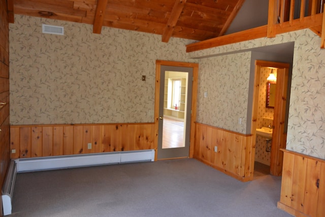 empty room with vaulted ceiling with beams, a baseboard heating unit, light colored carpet, and wood ceiling