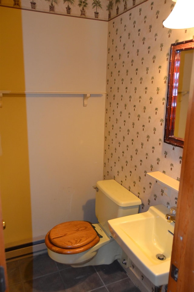 bathroom with tile patterned flooring, sink, toilet, and baseboard heating