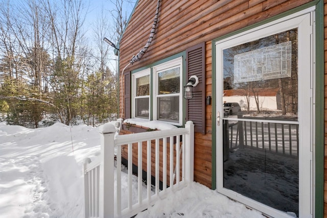 view of snow covered property entrance