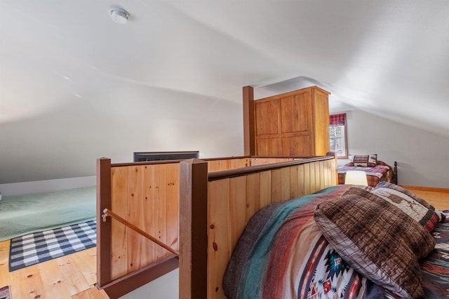 bedroom featuring vaulted ceiling and light hardwood / wood-style flooring