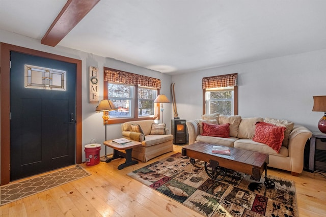 living room featuring beamed ceiling and hardwood / wood-style floors