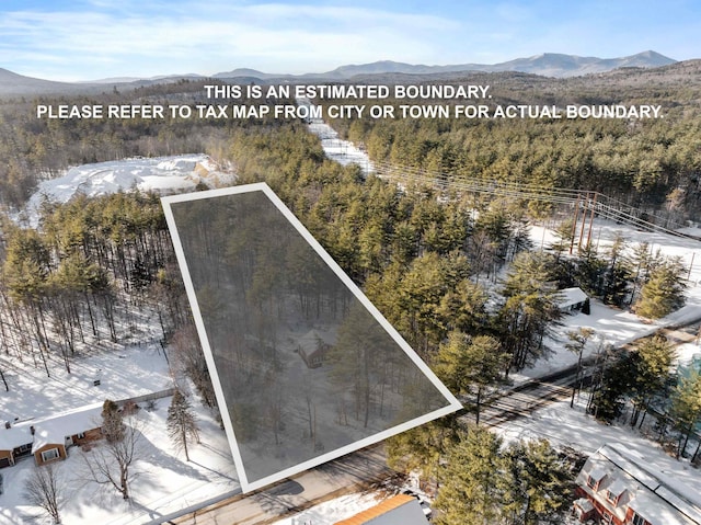 snowy aerial view with a mountain view