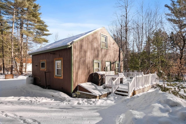 view of snowy exterior featuring a wooden deck