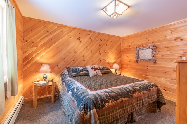 bedroom featuring wooden walls, carpet floors, and a baseboard heating unit