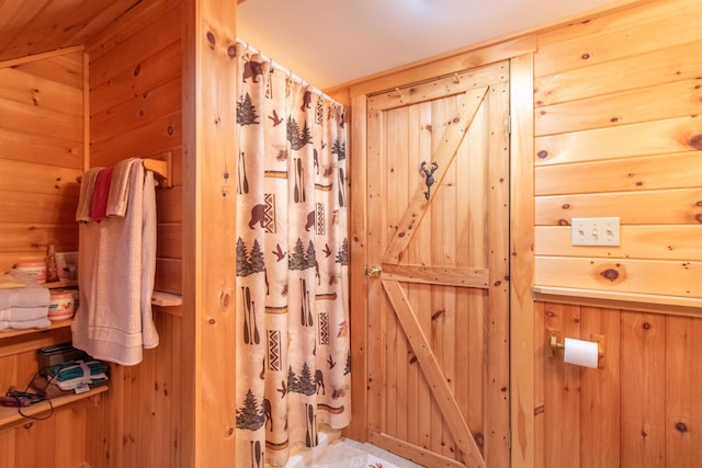 bathroom featuring wooden walls