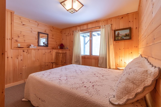 carpeted bedroom with wooden walls