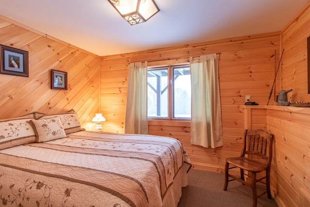 carpeted bedroom featuring wood walls