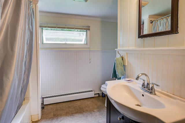 bathroom featuring baseboard heating, crown molding, sink, and shower / bath combo with shower curtain